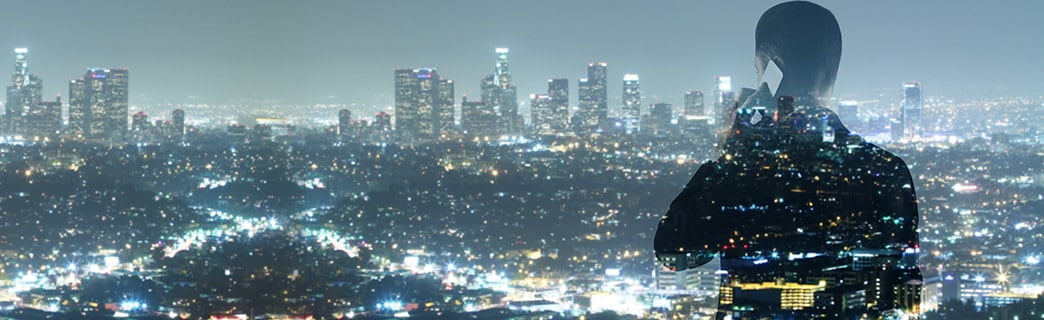  A man talking on the phone and looking at the city